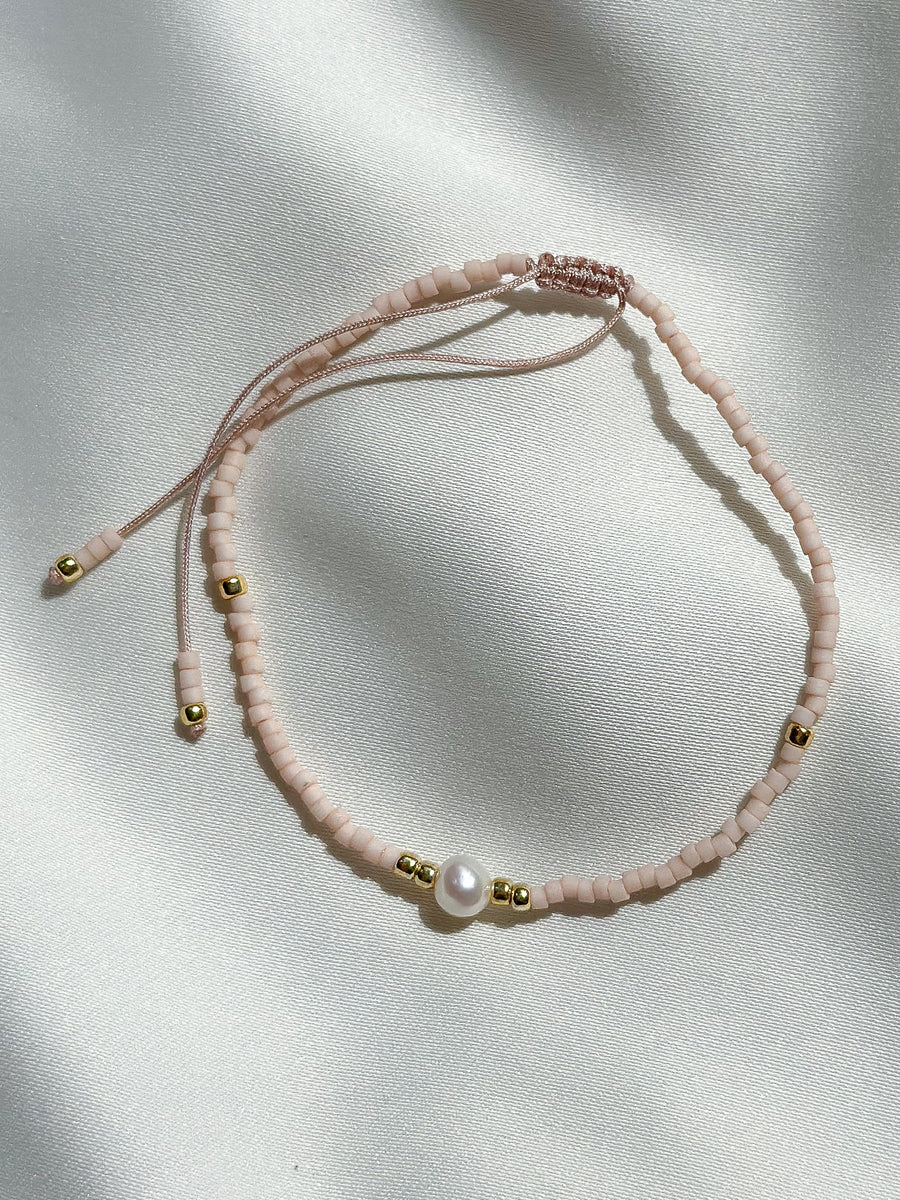 Schuif armbandje miyuki kraaltjes en pareltje - licht roze mat